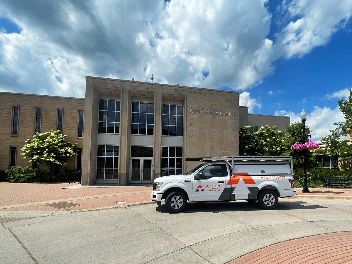 Action Overhead garage door repair truck at sunset